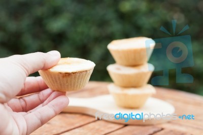 Woman's Hand Holding Mini Pies Stock Photo