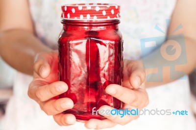 Woman's Hand Holding Red Glass Stock Photo