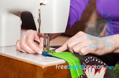 Woman's Hands Sewing On The Sewing Machine Stock Photo