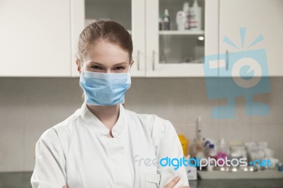 Women Doctor With Face Mask In The Office Stock Photo