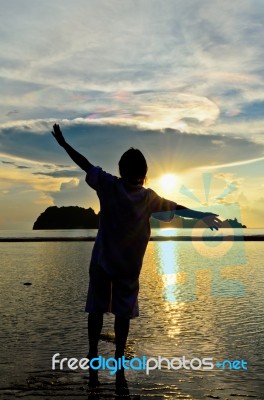 Women Happy Sunrise At The Beach Stock Photo