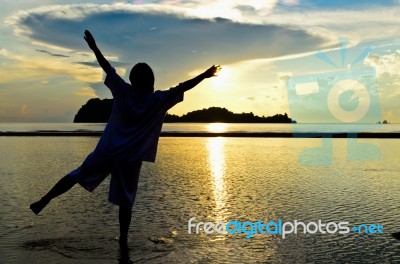 Women Happy Sunrise At The Beach Stock Photo