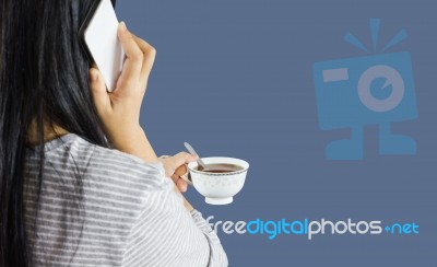 Women Hold Cup Of Coffee And Talking On Mobile Or Smartphone Stock Photo