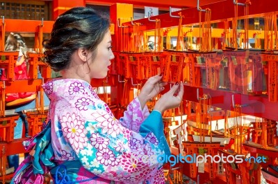 Women In Traditional Japanese Kimonos At Fushimi Inari Shrine In Kyoto, Japan Stock Photo