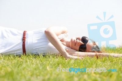 Women Lie Down On Grass Stock Photo