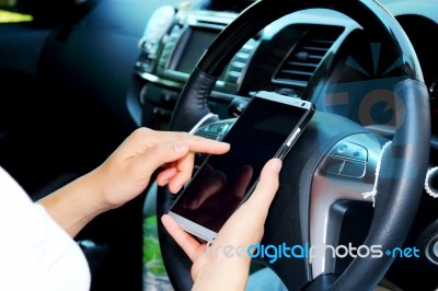 Women Using Smart Phone In The Car Stock Photo