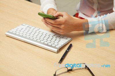 Women With Cell Phone In Office Stock Photo