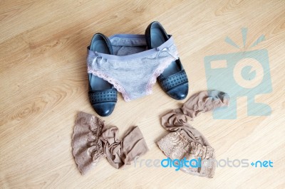 Women's Shoes, Panties And Stockings Lying On The Floor Stock Photo