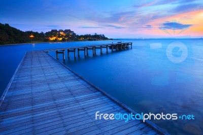 Wood Bridge Pier Into Blue Sea At Morning Time Stock Photo