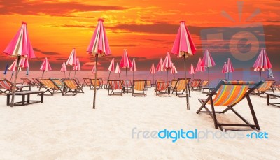 Wood Chairs On Sea Beach With Dramatic Sky Background Stock Photo