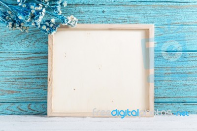 Wood Frame On Blue Wooden Background Stock Photo