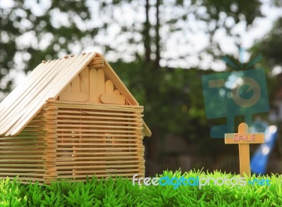 Wood Home For Sale On Green Grass Field Stock Photo