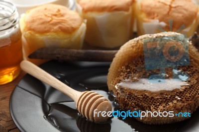 Wood Honey Dipper With Soft Cake Still Life Closeup Stock Photo