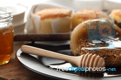 Wood Honey Dipper With Soft Cake Still Life Closeup Stock Photo