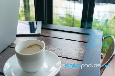 Wood Table In The Restaurant With Coffee And Laptop Stock Photo