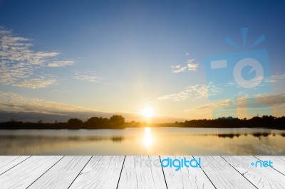 Wood Table Top On Blur Sunrise Background/ Use For Montage On Product Display Stock Photo