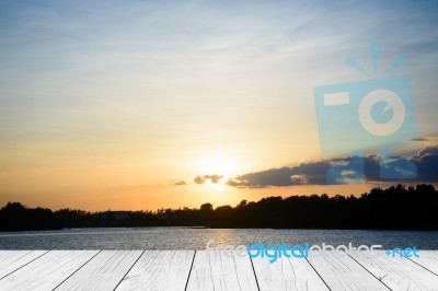 Wood Table Top On Blur Sunrise Background/ Use For Montage On Product Display Stock Photo