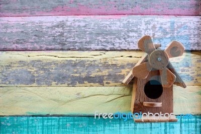 Wooden Bird House On Grunge Colorful Wooden Panel Stock Photo