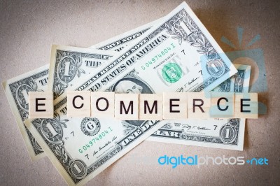 Wooden Block Word E-commerce And Dollar Banknote Stock Photo