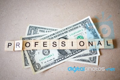 Wooden Block Word Professional And Dollar Banknote Stock Photo