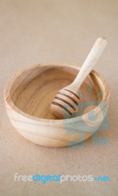 Wooden Bowl And Dipper On Brown Background Stock Photo