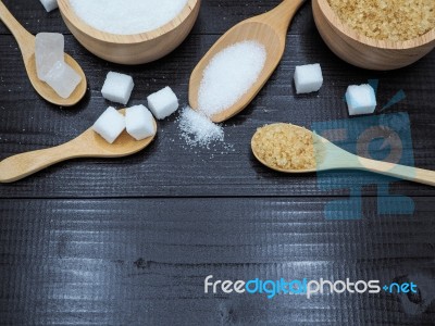 Wooden Bowl And Spoon With Sugar Cube On Dark Wood Background Stock Photo