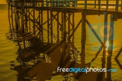 Wooden Bridge And The Reflection Of The Sun Stock Photo