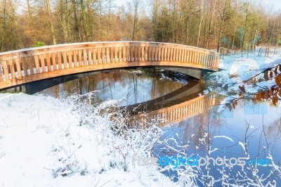 Wooden Bridge Snow And Water In Winter Season Stock Photo