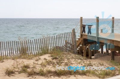 Wooden Bridge Through Sand Dunes Stock Photo