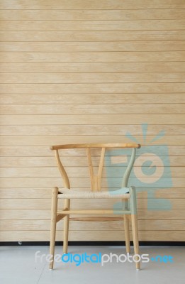 Wooden Chair With Wooden Wall In Background Stock Photo