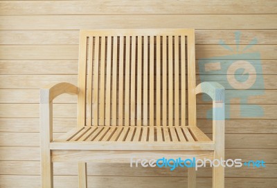 Wooden Chair With Wooden Wall In Background Stock Photo