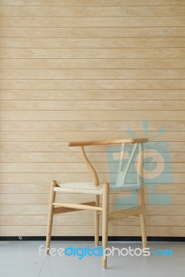 Wooden Chair With Wooden Wall In Background Stock Photo