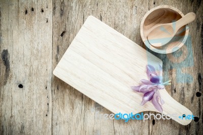 Wooden Chopping Board On Old Wooden Table. Top View Stock Photo