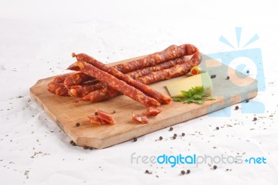 Wooden Chopping Board With Sausages And Spices Stock Photo