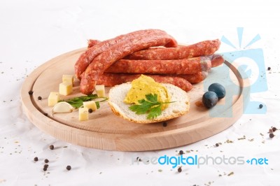 Wooden Chopping Board With Sausages, Cheese, Bread Stock Photo