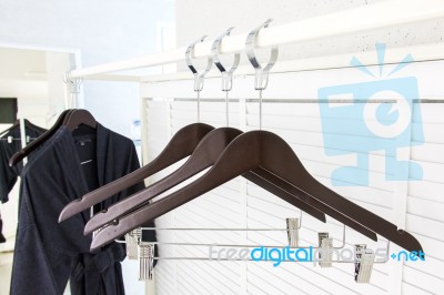 Wooden Cloth Hangers On Clothes Rail And Bathrobe Stock Photo