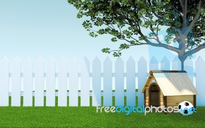 Wooden Dog Kennel Under Tree Shade On Green Grass Meadow With Soccer Ball And White Wooden Fence Stock Image