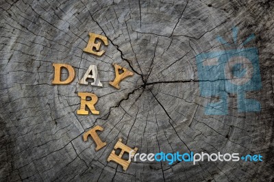 Wooden Earth Day Word On Wood Log Background Stock Photo