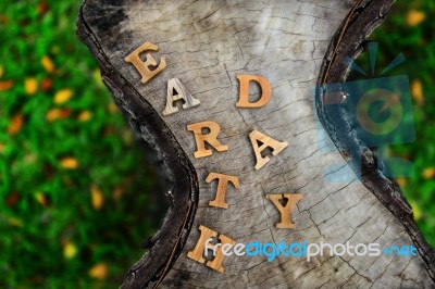 Wooden Earth Day Word On Wood Log Background. Save The Earth Idea Stock Photo