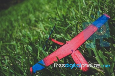 Wooden Glider Lying In Grass Broken Stock Photo