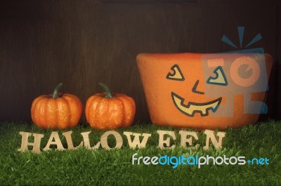 Wooden Halloween Words And Pumpkin On Grass Background Stock Photo