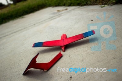 Wooden Painted Glider Lying Broken On A Sidewalk Stock Photo