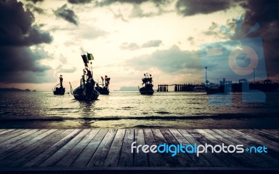 Wooden Pier With Many Fishing Boat In The Sea Stock Photo