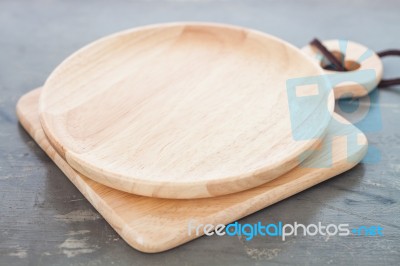 Wooden Plate On Gray Background Stock Photo