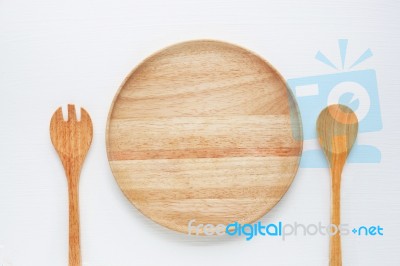 Wooden Plate With Spoon And Fork On White Background Stock Photo