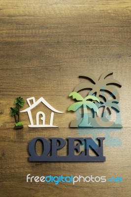 Wooden Sign Of House And Palm Tree With Open Sign Stock Photo