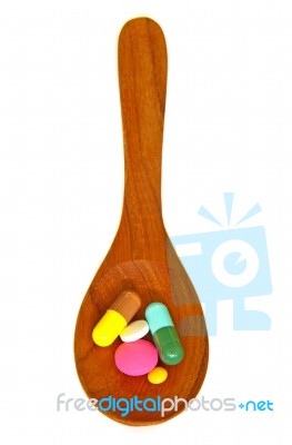 Wooden Spoon With Pills Stock Photo