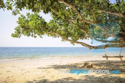 Wooden Swing On Tropical Beach Background Stock Photo