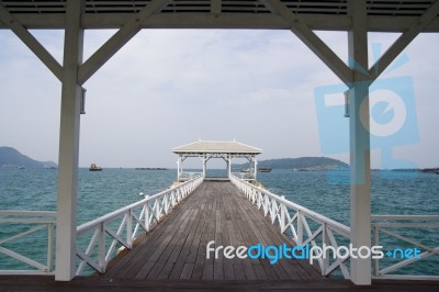 Wooden White Bridge Into The Sea Stock Photo