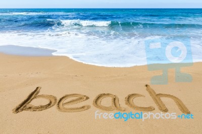 Word Beach On Sand Coast With Blue Sea Stock Photo